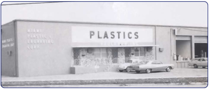 Vintage photo of Faulkner Plastic's first acrylic fabrication shop where workers cut and shaped plastic materials.